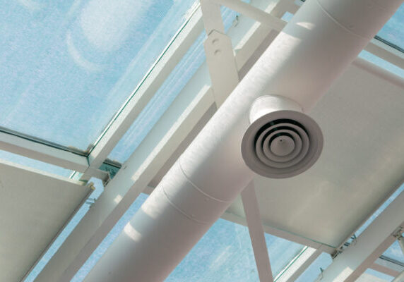 White ventilation pipe on the polycarbonate transparent ceiling. Copy space.